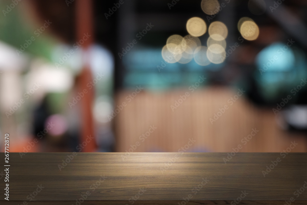 Empty dark wooden table in front of abstract blurred bokeh background of restaurant . can be used for display or montage your products.Mock up for space.