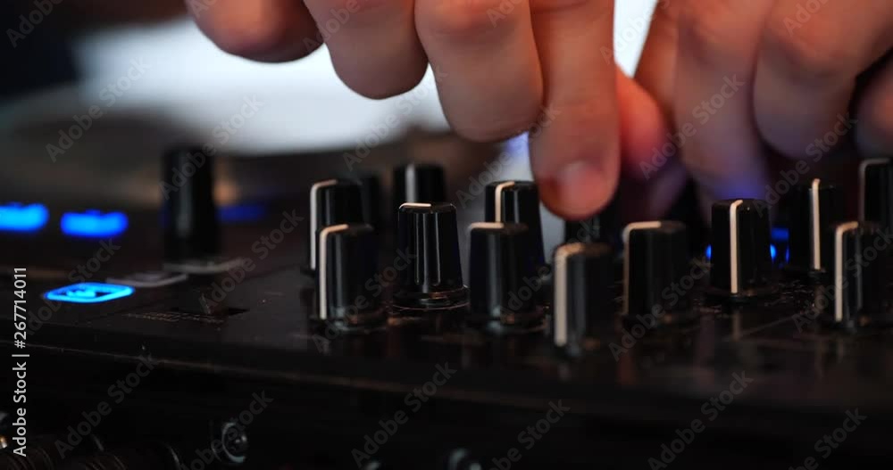DJ turning knobs on turntables DJ turning knobs on turntables
