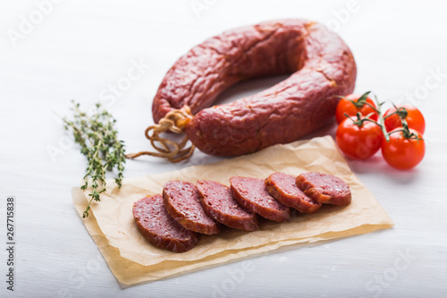 Food, meat and delicious concept - sausages made with horse meat with species and vegetables