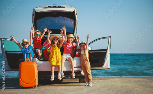 Photography group happy children girls and boys friends   on   car ride to summer trip
