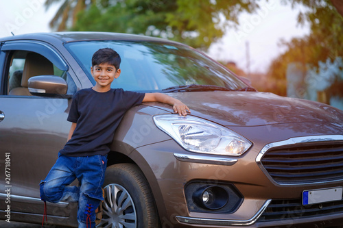 Cute Indian child with car © Niks Ads