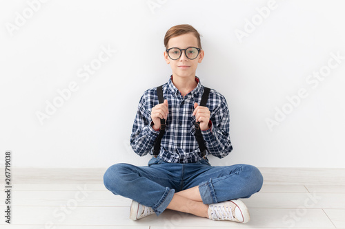 teenager, children and fashion concept - Funny boy with glasses and shirt suspenders © satura_