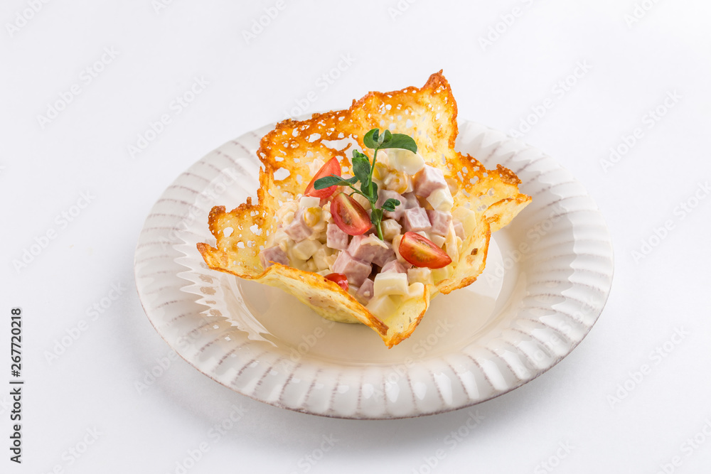 Russian traditional salad Olivier in crispy cheese isolated on white background Russian traditional salad Olivier in crispy cheese isolated on white background