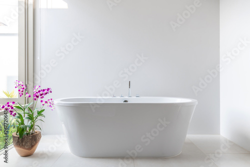 Luxury bathroom features bathtub with flower