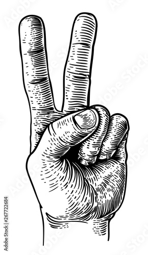 A hand in a peace or v for victory sign. Iin a vintage antique engraving woodblock or woodcut style.