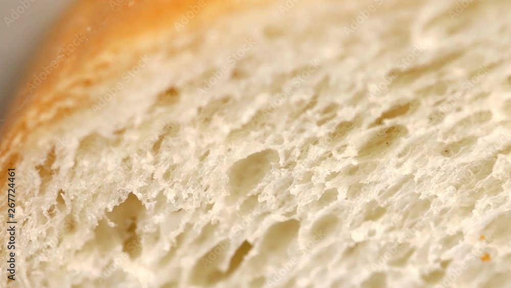 Macro shot of white bread slice texture. Closeup. Selective focus. Slow pan. Macro shot of white bread slice texture. Closeup. Selective focus. Slow pan.