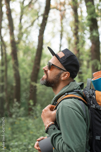 A young guy with a backpack in the cap, traveller in the woods, Hiking, Forest, Journey