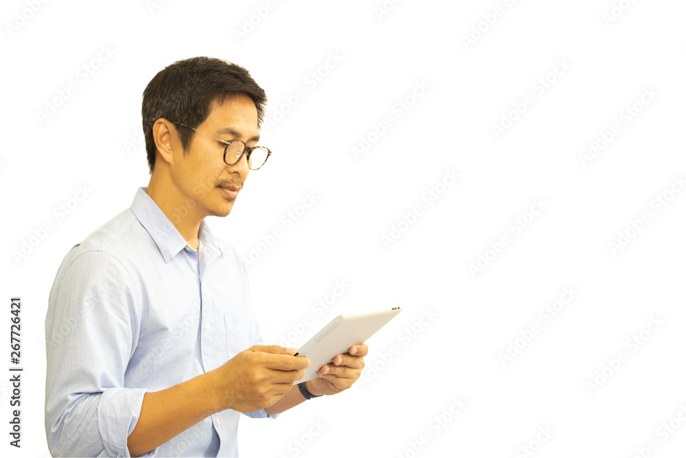 Asian man with eyeglasses looking at tablet isolated in clipping path. Asian man with eyeglasses looking at tablet isolated in clipping path.