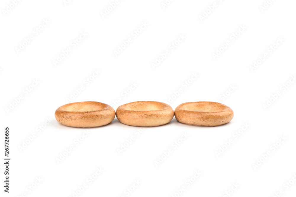 Three crispy bagels isolated on white background. Three crispy bagels isolated on white background.
