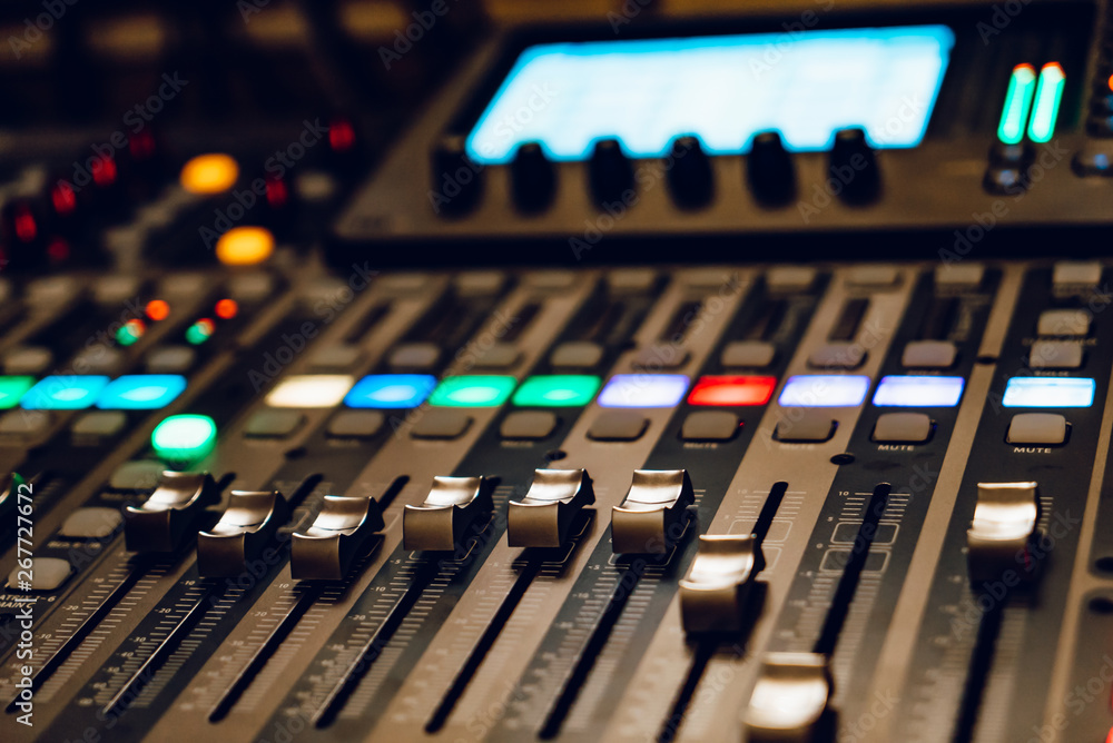 Professional sound and audio mixer control panel with buttons and sliders. Sound recording studio mixing desk. Mixer control panel. Close-up. Professional sound and audio mixer control panel with buttons and sliders. Sound recording studio mixing desk. Mixer control panel. Close-up.