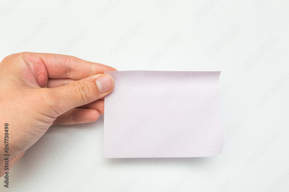 Green post-it note with hand on white background Green post-it note with hand on white background
