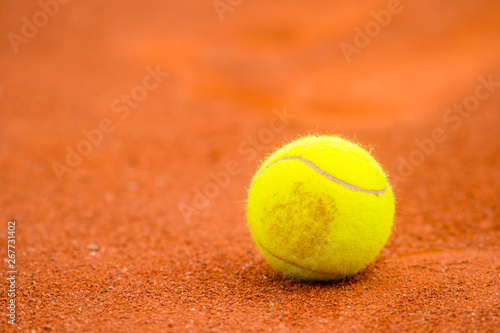 Tennis ball on a tennis clay court