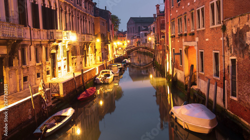 Venice, Italy. Boats in canal at night city. Venezia cityscape. Old street in Venice island with illumination