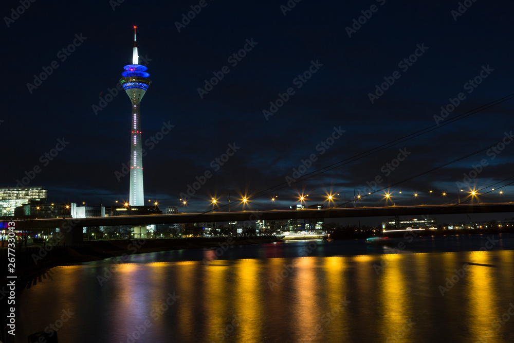 View of the center of Dusseldorf, river Rhine and the TV tower in night, Germany