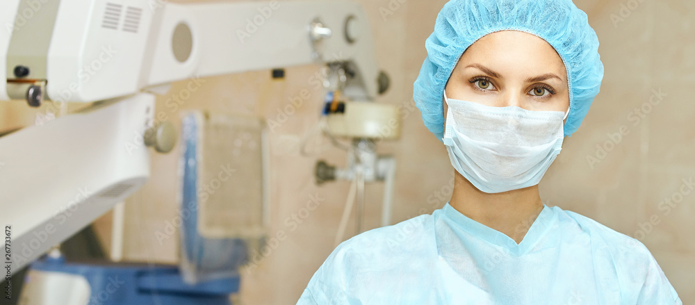 Pretty doctor woman portrait. Ophthalmology laser microscope operation. Clinic room. Patient eye treatment. Myopia and cataract removal - obrazy, fototapety, plakaty 