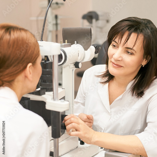 Eye ophthalmologist exam. Eyesight recovery. Astigmatism check concept. Ophthalmology diagmostic device. Beauty girl portrait in clinic © elenavolf