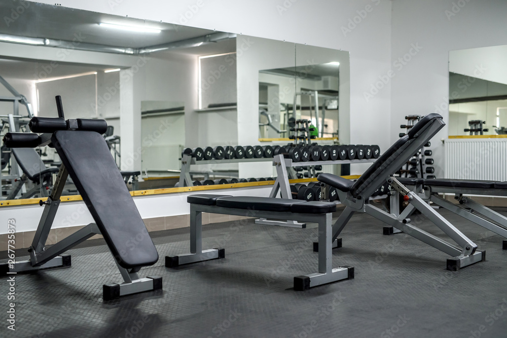 Modern interior of light gym with different equipment
