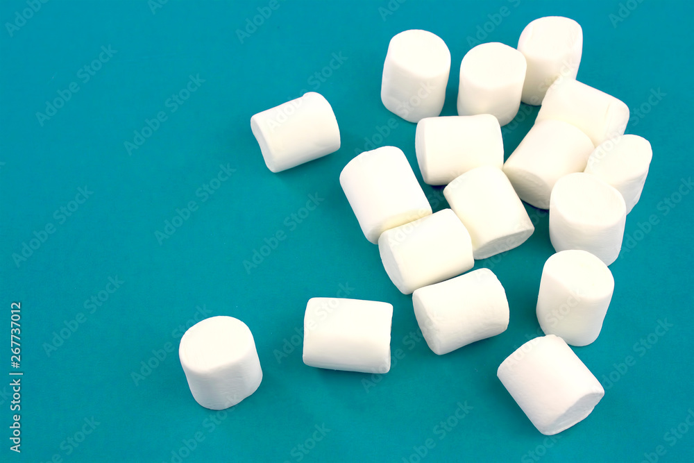Mini marshmallows on a blue background. geometric pattern of white marshmallows. Mini marshmallows on a blue background. geometric pattern of white marshmallows.
