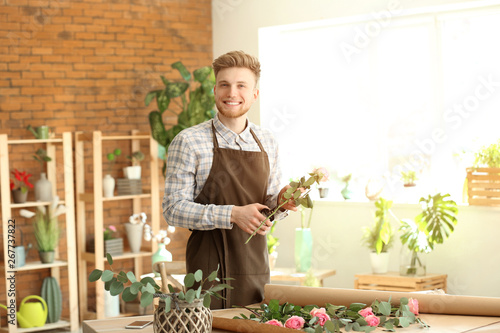Young male florist working ...