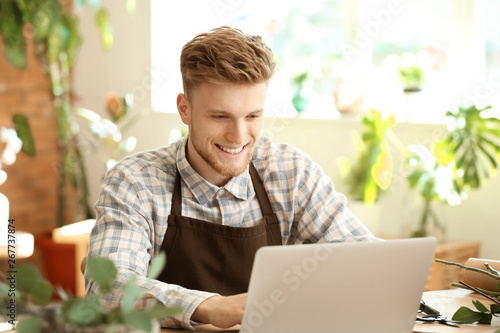 Young florist working with ...