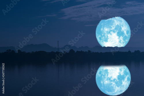 strawberry moon on night sky back silhouette mountain reflection on river