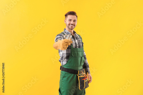 Male electrician on color background photo