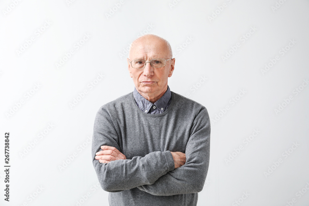 Portrait of elderly man on light background Portrait of elderly man on light background