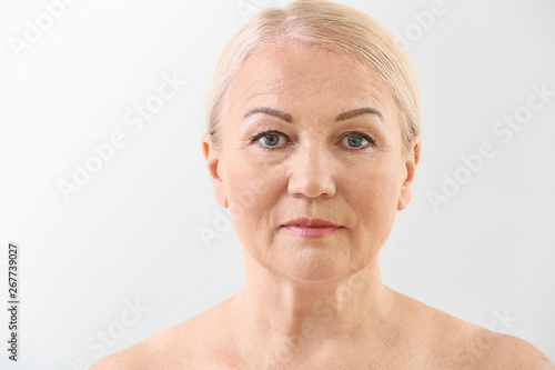 Mature woman on light backg...