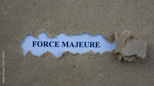 Torn paper with text force majeure photo