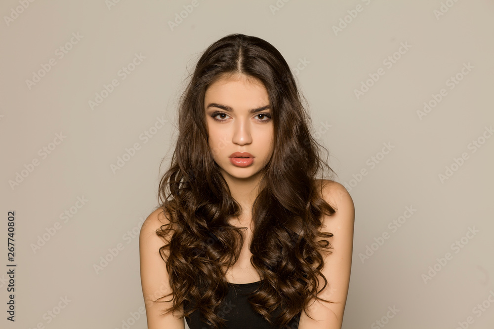Young woman with makeup and long hair, posing on white background Young woman with makeup and long hair, posing on white background