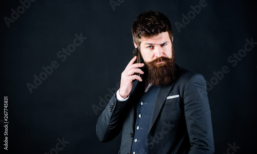 Concentrated on work. brutal caucasian hipster with moustache. Male formal fashion. businessman in suit. business communication. Mature hipster with beard speak on phone. Bearded man with smartphone