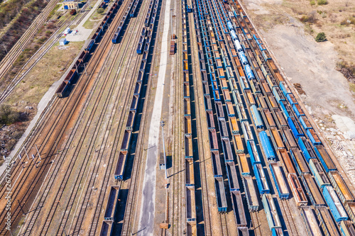 Cargo trains. Aerial view of colorful freight trains on the railway station. Wagons with goods on railroad.Aerial view