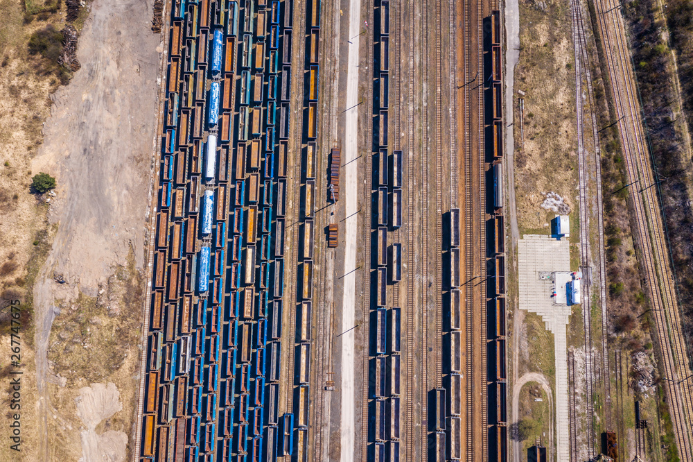 Obraz premium Cargo trains. Aerial view of colorful freight trains on the railway station. Wagons with goods on railroad.Aerial view