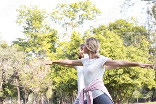 Couples are exercising in the park.