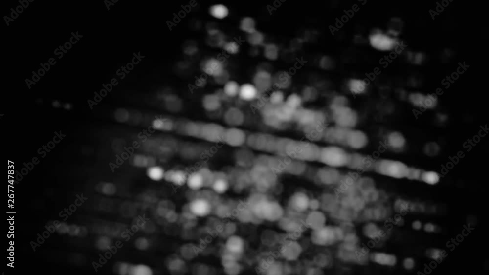 Blurred monochrome background with rotating rays of small circles ...