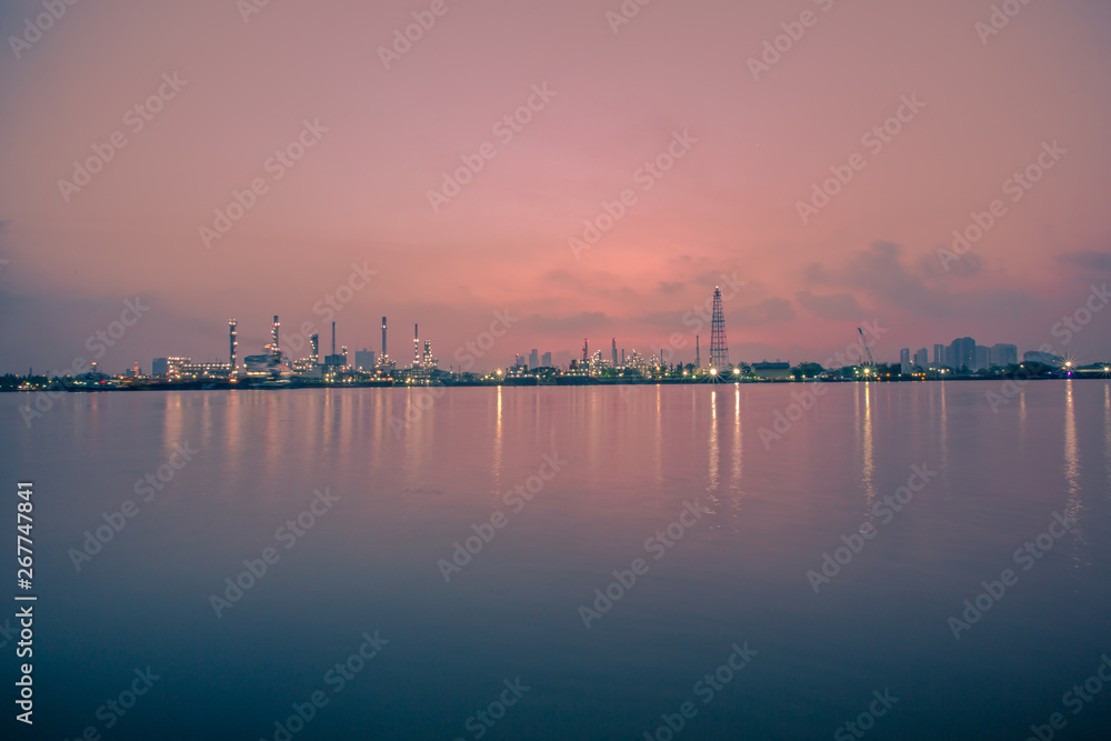 The blurred background of nature along the river, with views of the cargo ship, oil refinery, sunrise and beautiful sky in the morning