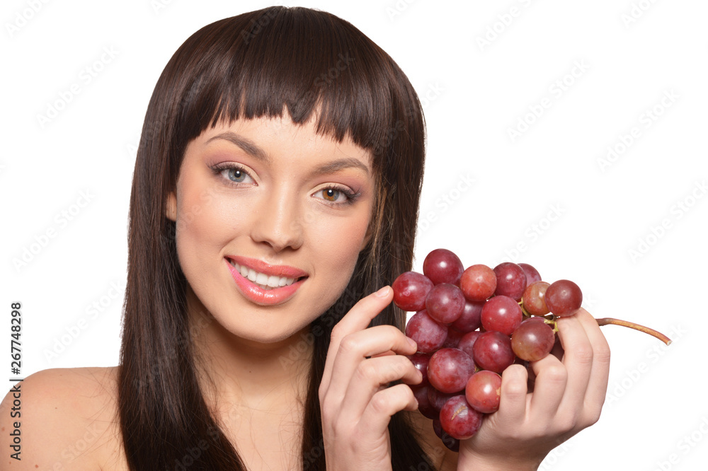 Young woman posing with grapes isolated on white background Young woman posing with grapes isolated on white background