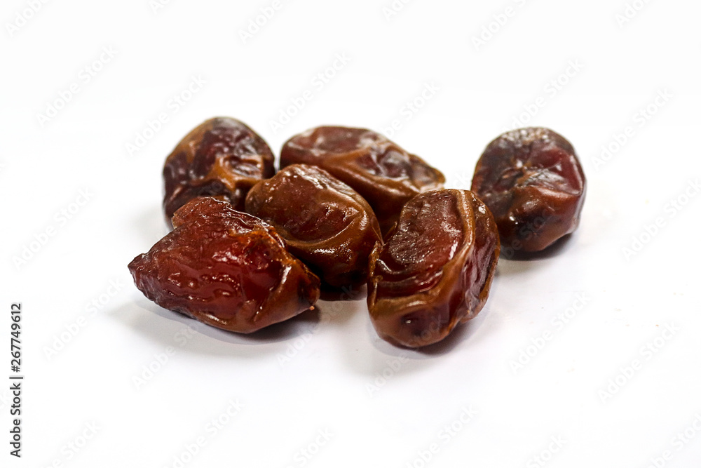 Kurma or dates fruits isolated on white background, Popular During Ramadhan or Fasting Month. Ramadhan food. Selective focus Kurma or dates fruits isolated on white background, Popular During Ramadhan or Fasting Month. Ramadhan food. Selective focus