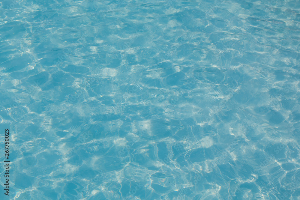 Blue pool water with sun reflection Blue pool water with sun reflection