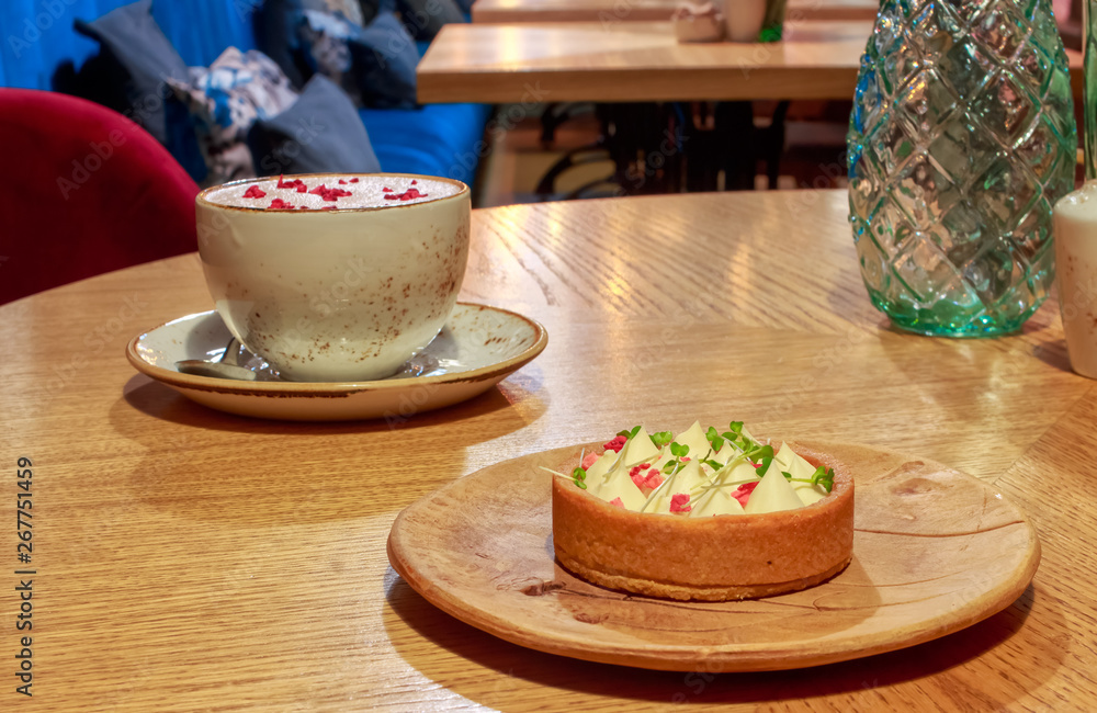 Cup raspberry Raf coffee in a vegetarian restaurant. Pink coffee based ...