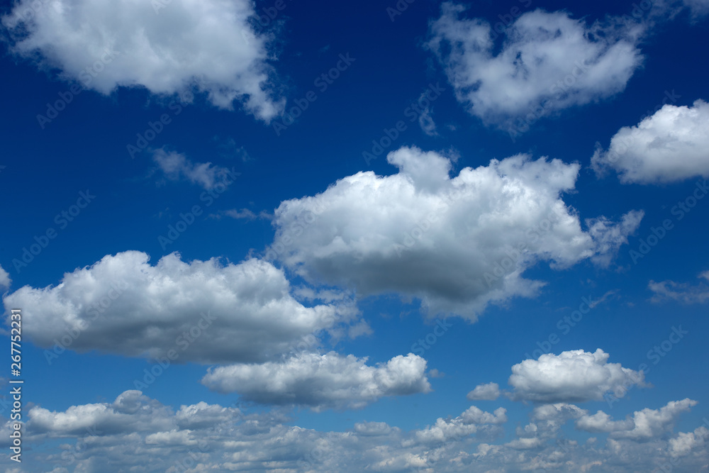 Blue sky with perfect white fluffy clouds receding to horizon Blue sky with perfect white fluffy clouds receding to horizon
