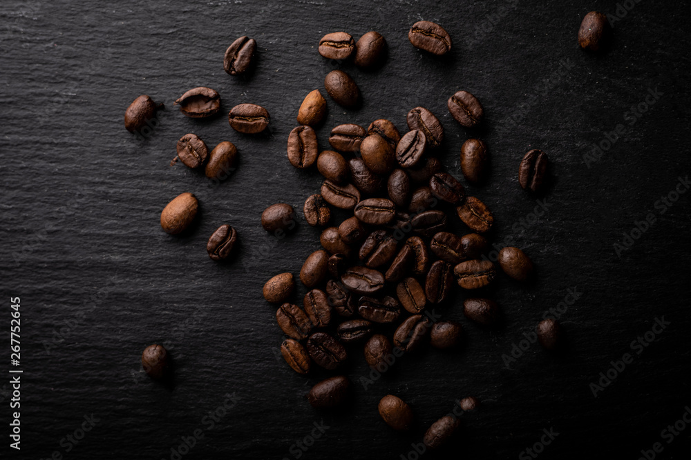 Coffee beans. Roasted coffee fries on a dark table. Coffee beans. Roasted coffee fries on a dark table.