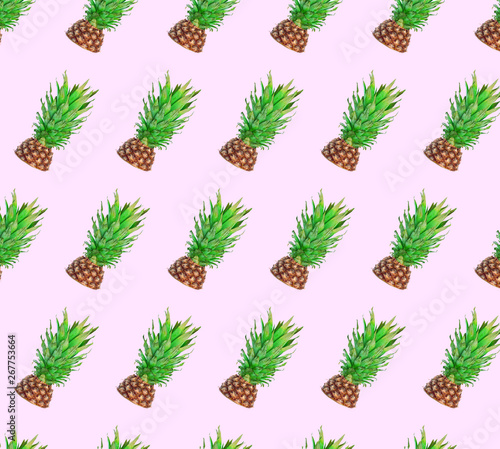 Colorful fruit pattern of fresh pineapples on color background. From top view