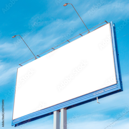 Obraz na płótnie Billboard on the background of a beautiful blue cloudy sky. Mock up for your advertising or announcements w salonie