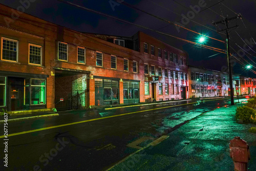 Torrington, Connecticut, USA The old industrial mill town landscape at night on Water Street. photo