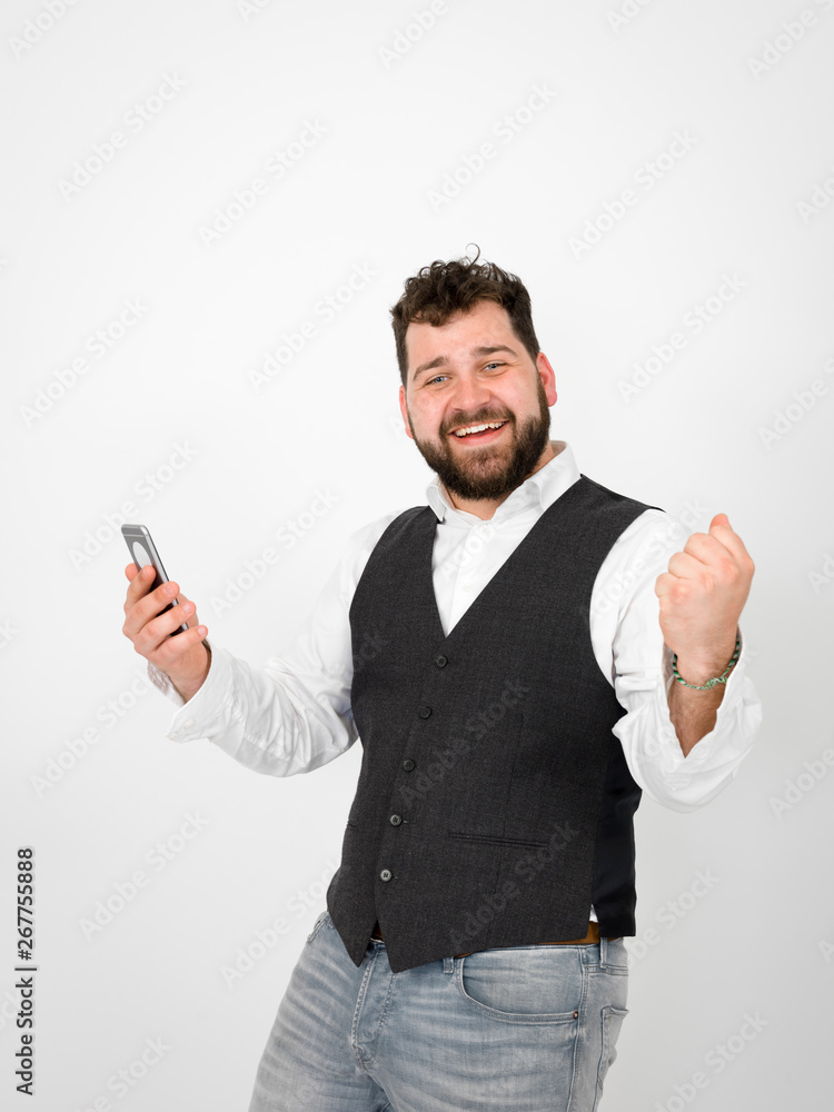 young man with black beard is posing and looking at his smartphone in front of white background with different emotions young man with black beard is posing and looking at his smartphone in front of white background with different emotions
