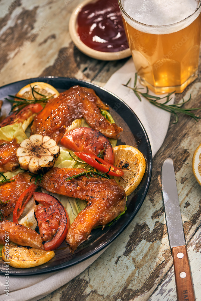 Grilled chicken wings spiced with chili peppers and rosemary Grilled chicken wings spiced with chili peppers and rosemary