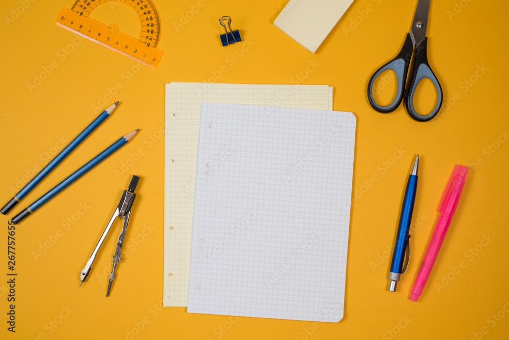 Back to school. Notebook, pencil case with pen and pencils on yellow background