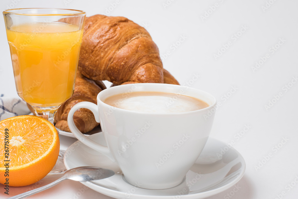Breakfast coffee with croissants and orange juice on a white background. Latte on a saucer and cellular cotton towel Breakfast coffee with croissants and orange juice on a white background. Latte on a saucer and cellular cotton towel