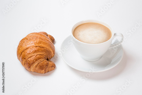 Breakfast coffee with croissants on a white background. Latte on a saucer